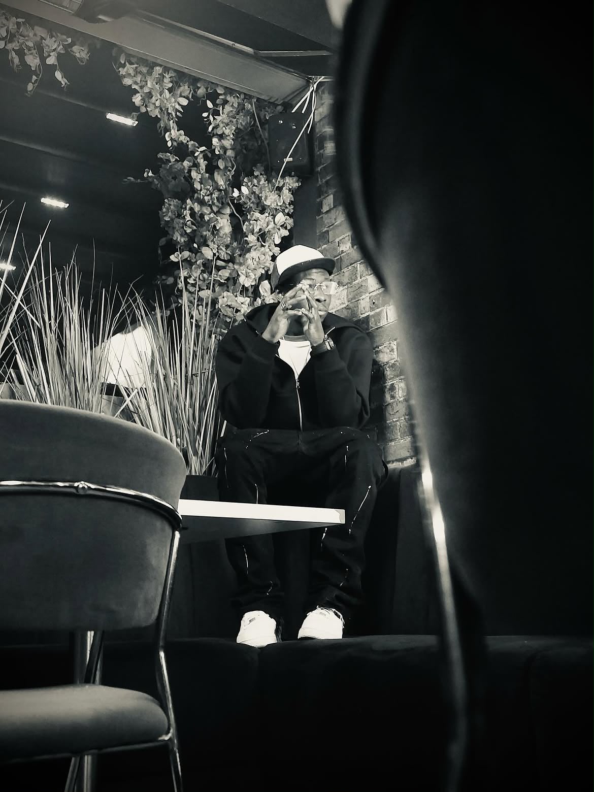 Black and white portrait in a moody bar interior