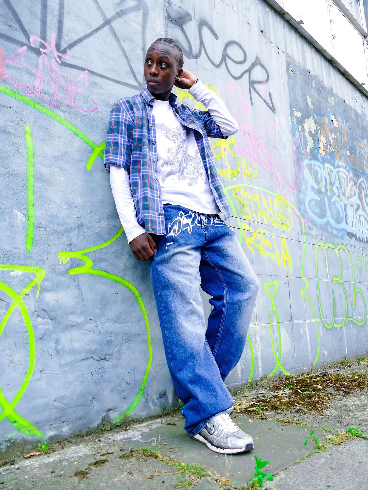 Street portrait against a graffiti wall